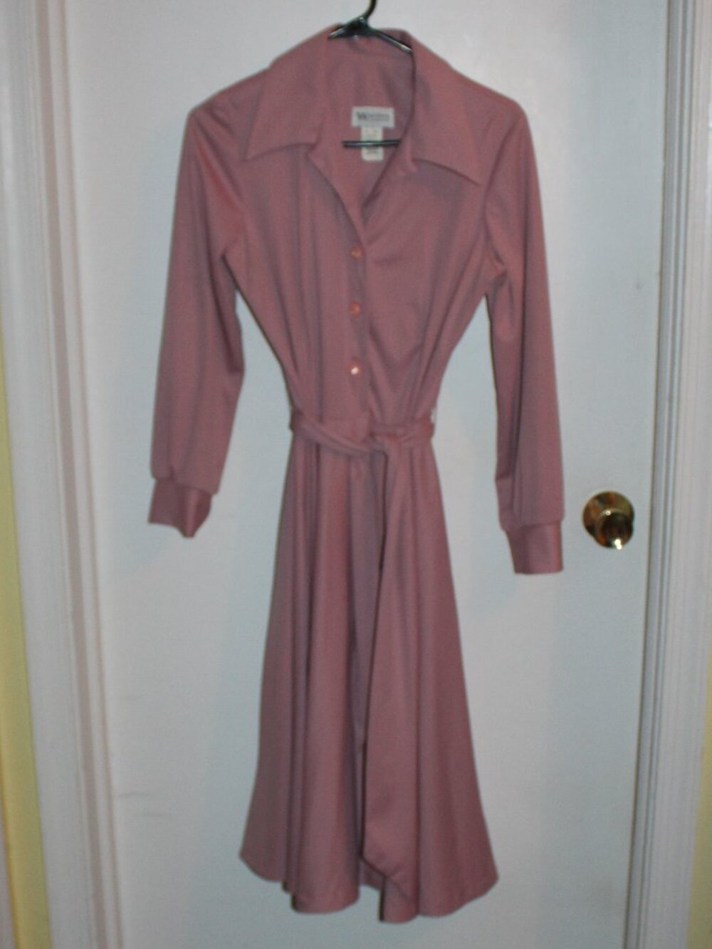 Vintage pink button-front shirtdress, a collared neckline, long sleeves, belt